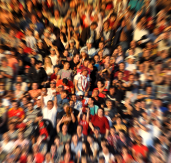 Blurred large group of spectators reflecting essential tips for working with large groups